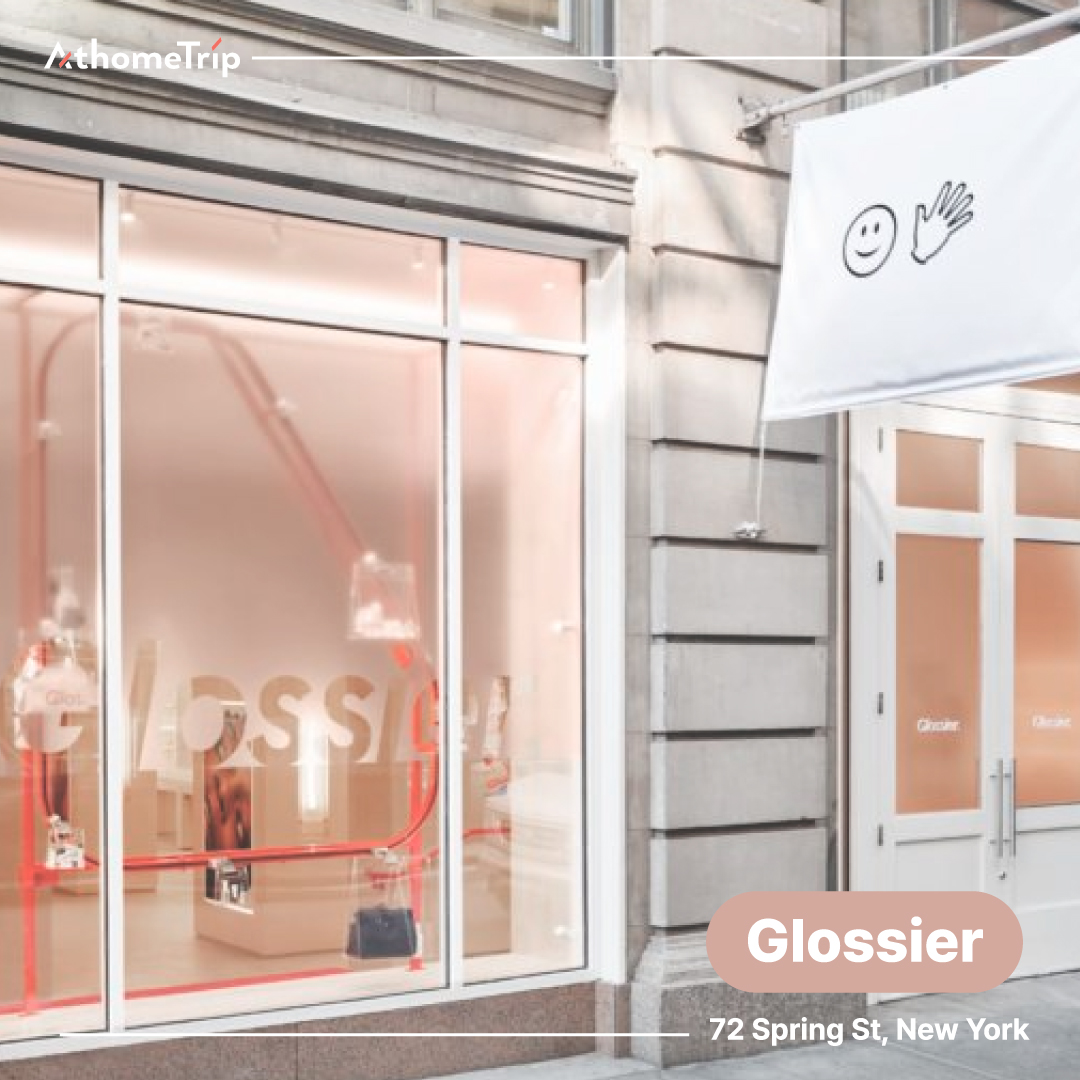 Glossier 문구와 주소가 적힌 뉴욕 소호의 상업 건물 유리창과 문