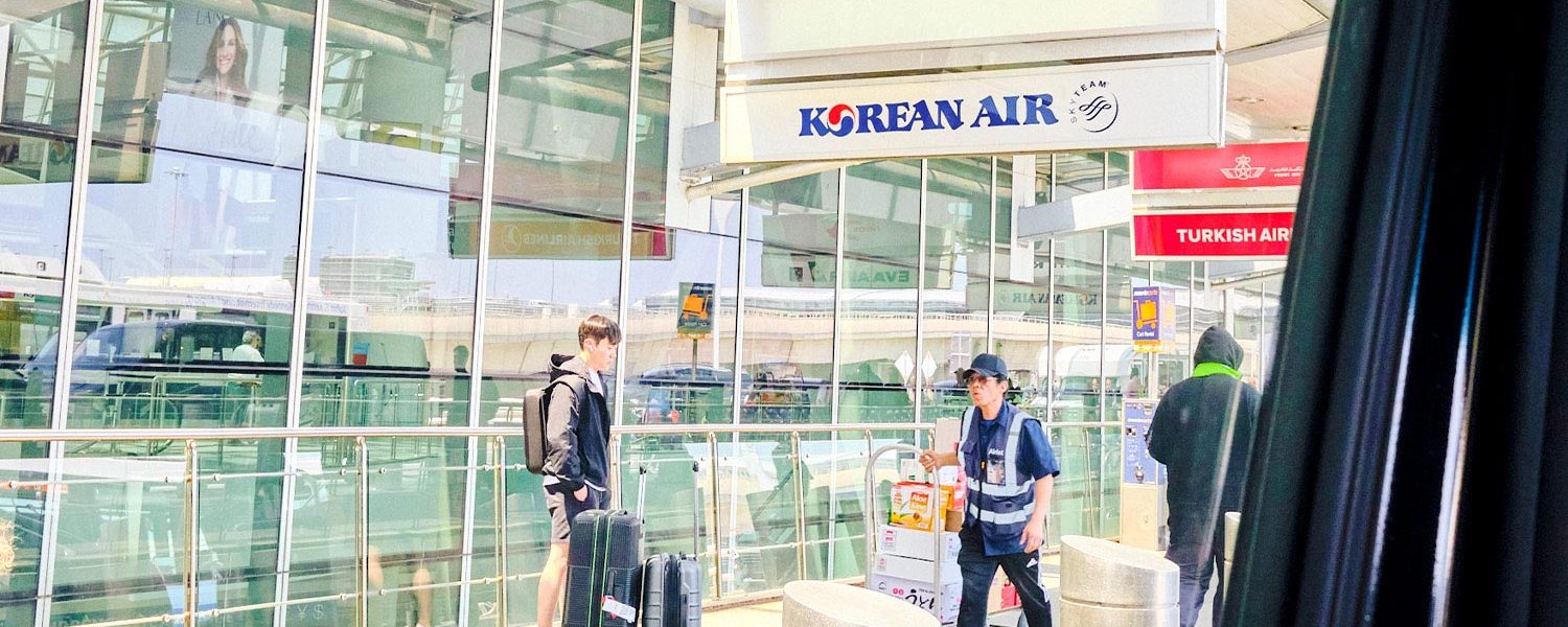 실내 장면. 확인되는 요소: 사람, 항공사 간판, 짐, 공항, 투명 패널, 인물